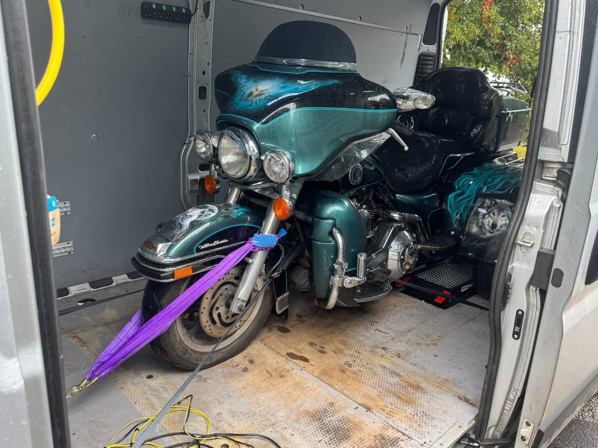 Custom trike secured inside an enclosed transport van