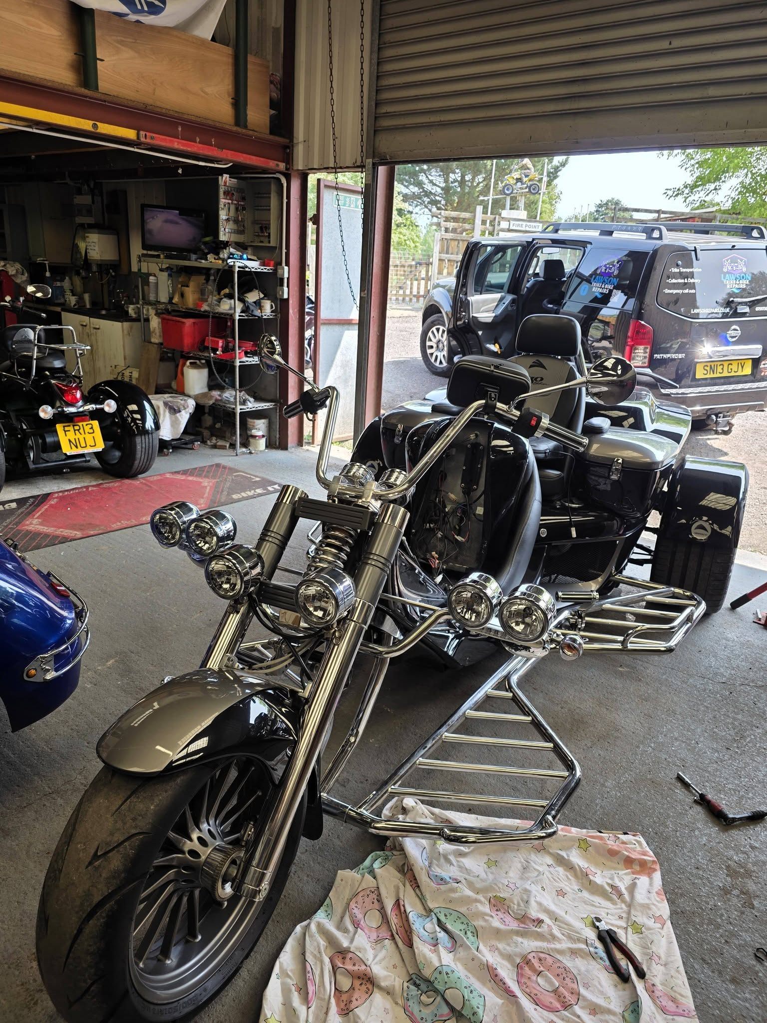 Custom trike in the workshop with Lawson recovery van outside
